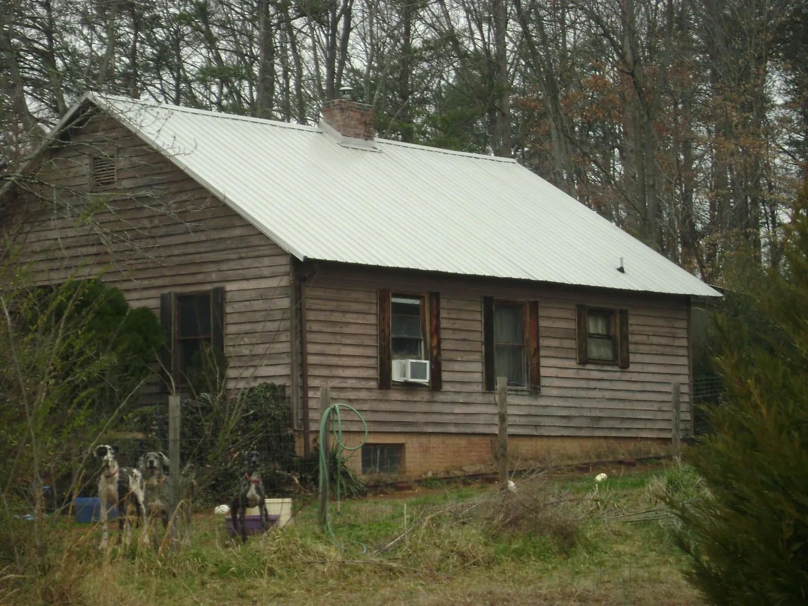 White metal roof on an old wood sided farmhouse, from a Metal Roof Installation job in Westford